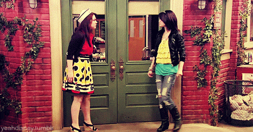 Two women kicking in a door and walking through.