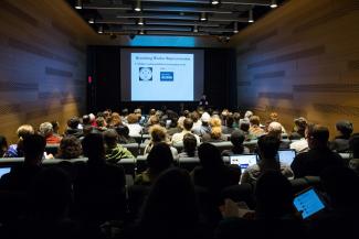 "Remaking worker representation" slide in front of full small auditorium