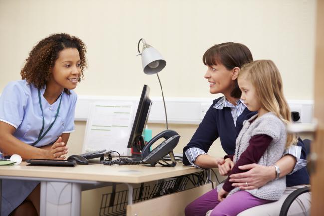 Doctor talking with a mother and daughter.